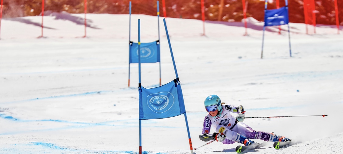 Bayli racing alpine slalom around a Loveland Ski Club gate