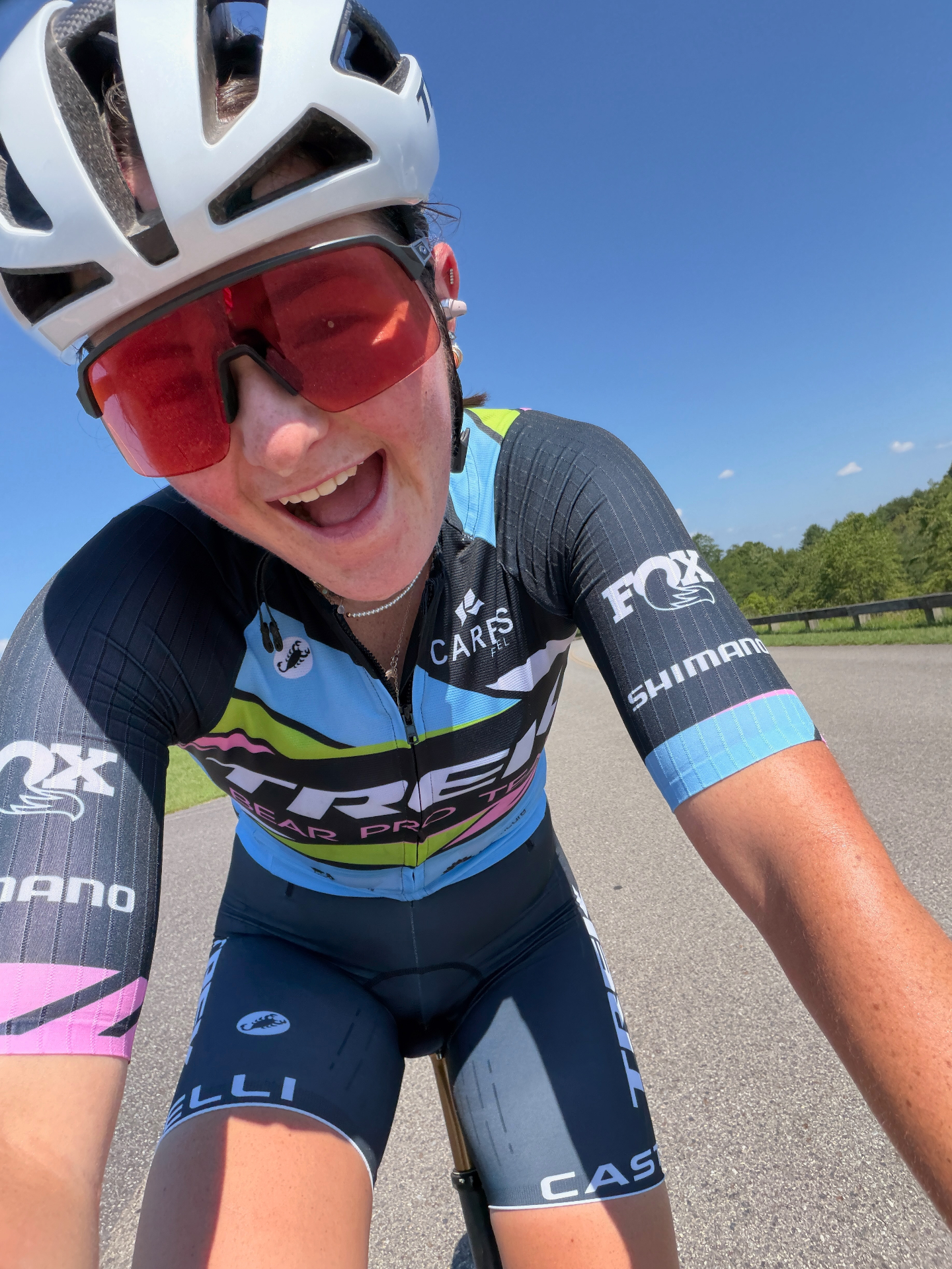 Bayli grinning ear-to-ear on a road ride in Trek Bear Pro Team kit