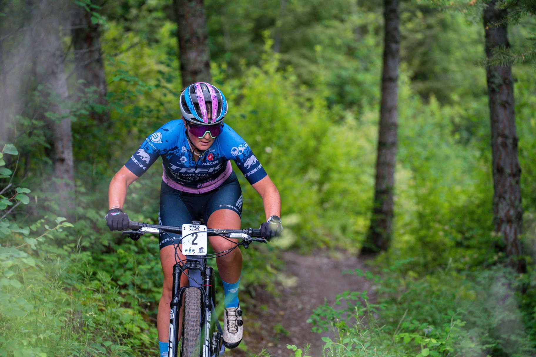 Bayli #2 charging through a Montana forest singletrack in Bear National Team kit